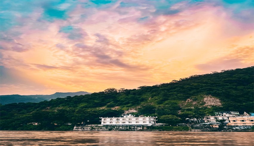 Sacred city of Rishikesh, India, nestled in the Himalayas beside the flowing Ganges River.